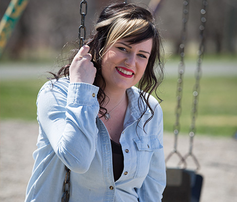 photo of a female on the swings at a park